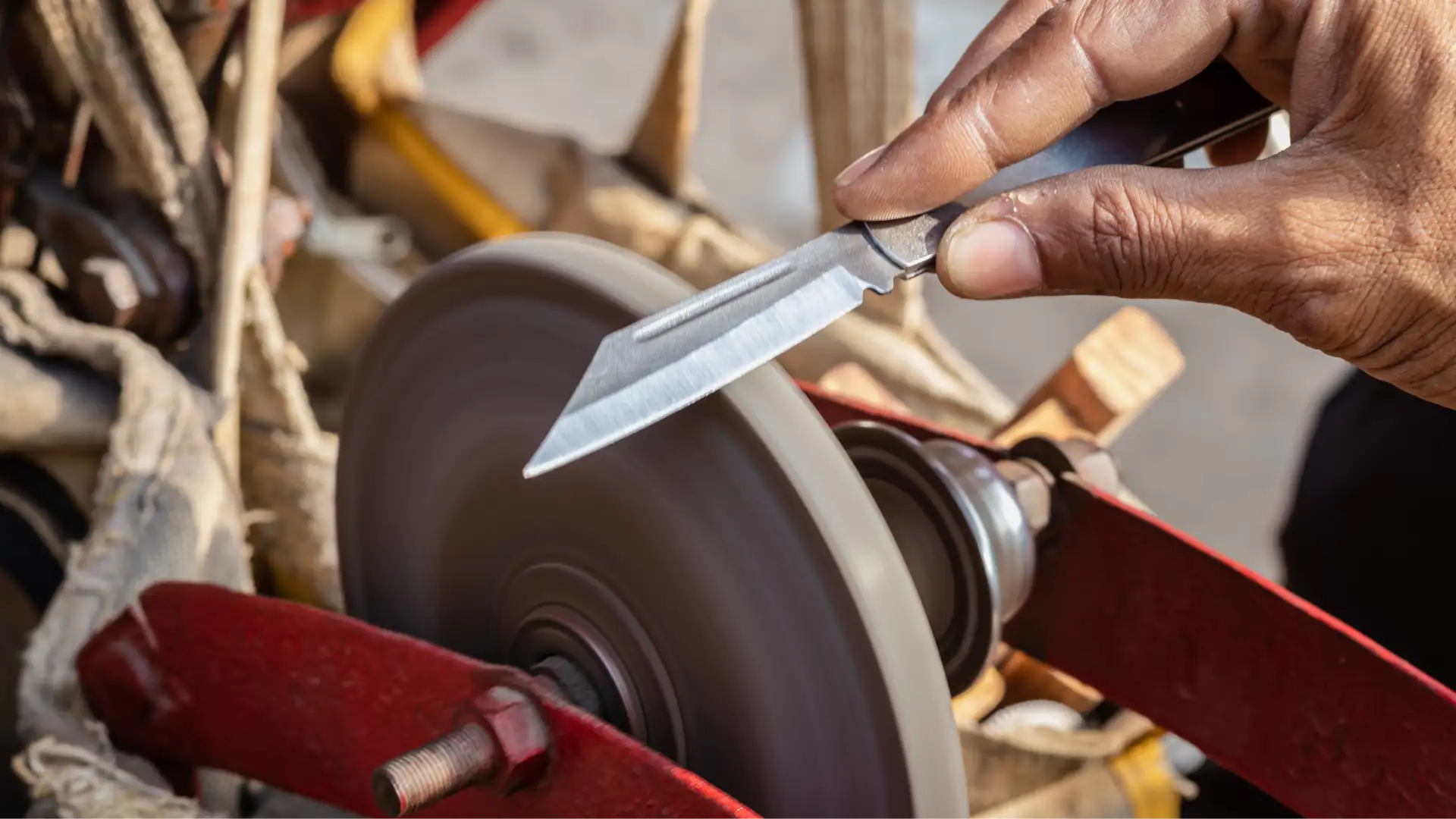 man-doing-knife-sharpen-iron-sharpener-from-different-angle 1_1x